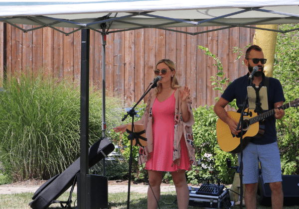 Two people singing outside at Henry of Pelham winery